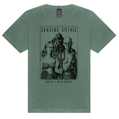 Seaside Gothic washed cotton t-shirt in Seaweed green, featuring a black hand screen-printed sea couple with mermaid tails and trident, inspired by Grant Wood's American Gothic. Hand screen printed using vegan, water based inks. Exclusively designed by Waves & Wild Water, South Wales.