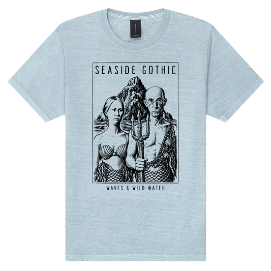 Seaside Gothic washed cotton t-shirt in pale blue Washed Ashore, featuring a black hand screen-printed sea couple with mermaid tails and trident, inspired by Grant Wood's American Gothic. Hand screen printed using vegan, water based inks. Exclusively designed by Waves & Wild Water, South Wales.