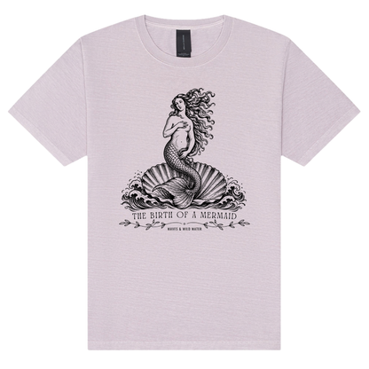 The Birth of a Mermaid washed cotton t-shirt in Sea Lavender, featuring a black hand screen-printed mermaid on a shell inspired by Botticelli's The Birth of Venus. Exclusive to Waves & Wild Water and hand printed in South Wales.