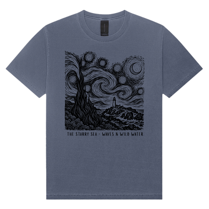 The Starry Sea washed blue cotton t-shirt in Midnight Tide, featuring a black hand screen-printed swirling night sky and coastal lighthouse inspired by Van Gogh's The Starry Night. Exclusively designed and hand printed by Waves & Wild Water, South Wales.