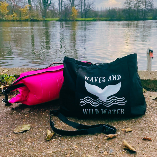 The gorgeous Night Sky Towel Tote bag from Waves and Wild Water. This versatile bag with front storage sleeve is shown in black with the whale tail logo in metallic silver print. Perfect for carrying kit for a wild swim in the river Thames, and other places!