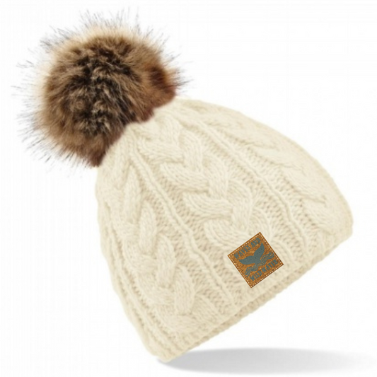 Introducing the Winter Swim cream-coloured cable knitted beanie hat, featuring a delightful faux fur pom pom! Perfect for those invigorating cold water dips and land-loving winter adventures.