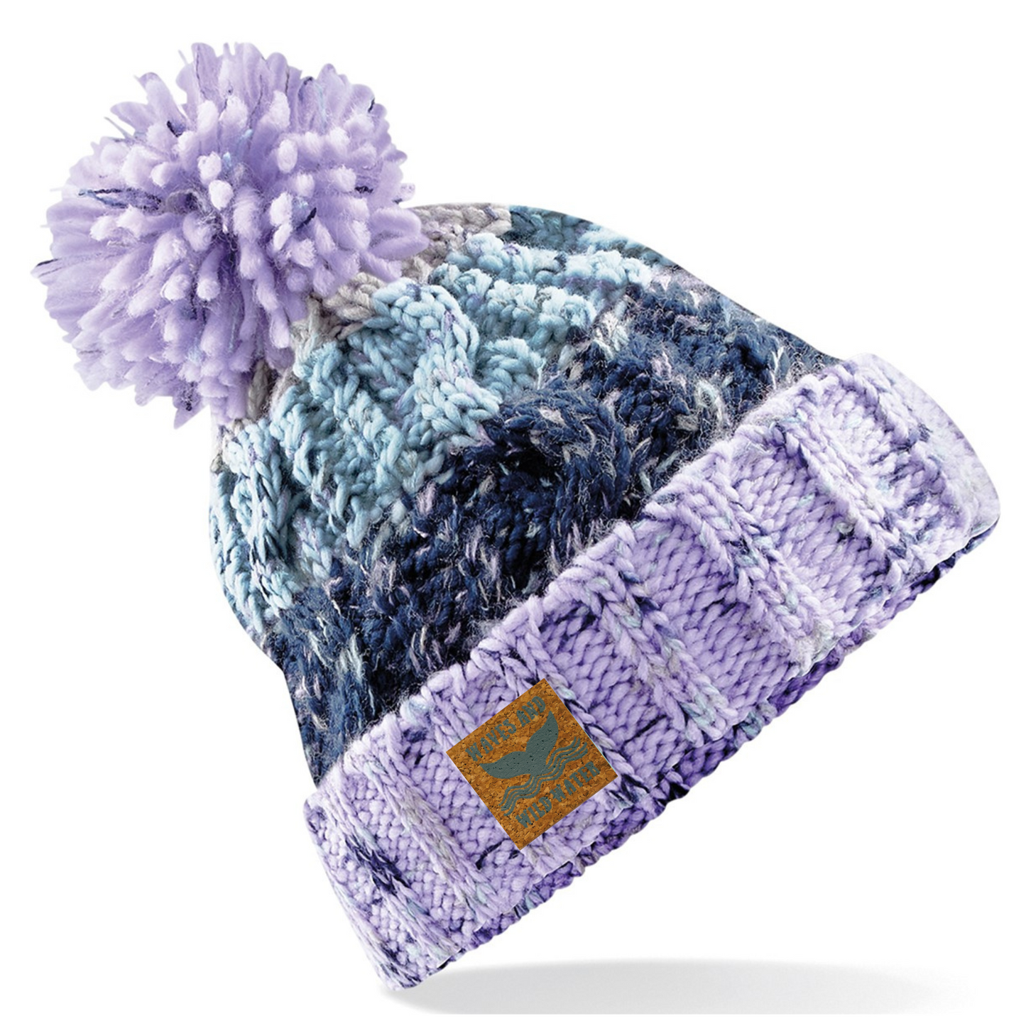 This hat is knitted in different shades of lilac, purple and blue. It has a deep fold up cuff which proudly displays the vegan leather Waves and Wild Water label. Finished with a fun fluffy pom pom, this hat is not only practical for keeping your head warm after a wild swim, it also looks great too. 