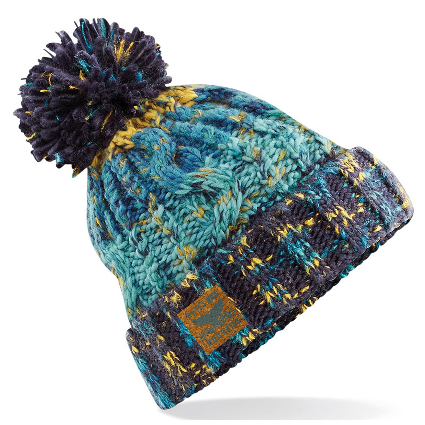 This fabulous knitted hat is shown in varying shades of blue and reminds us of the colours of the ocean. It has a thick fold up cuff for extra cosiness and is topped off with a woolly pom pom. We love to pop this hat on after a cold water dip or wild swim.