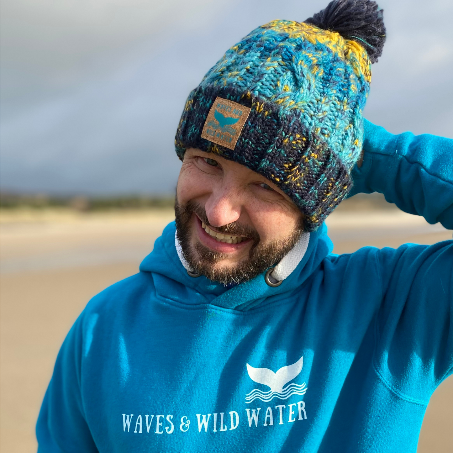 Waves and Wild Water owner Glenn, matches his Ocean Depths knitted beanie hat with is heavyweight hoodie. Both are super efficient for warming up after a cold swim in the sea, and they look great together too!