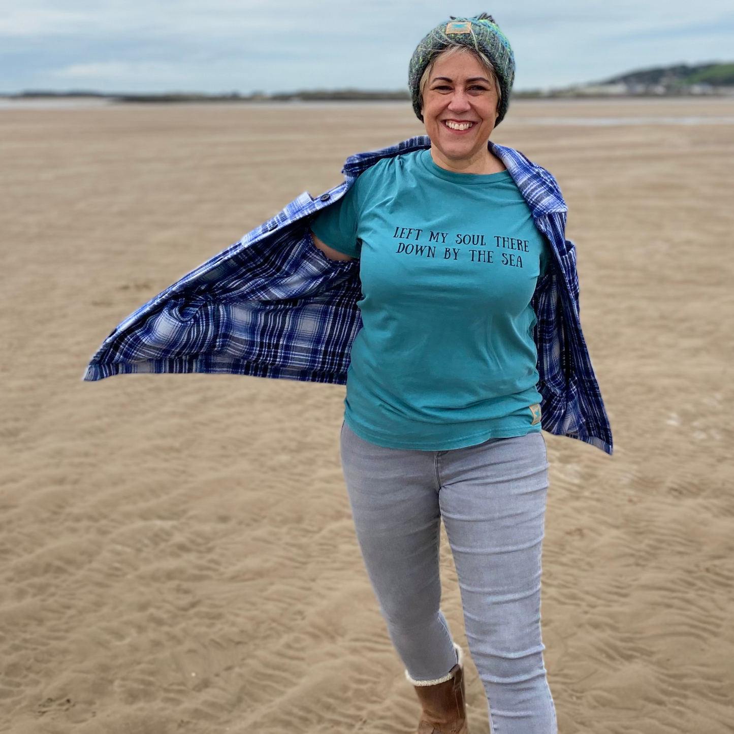 Waves and Wild Water owner Claire, teams her green River Bed knitted beanie with a Down By The Sea t-shirt - they look great together.