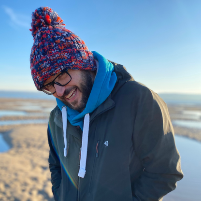 Check out wild swimmer Glenn, getting warm and snuggly in his chunky Campfire Embers beanie hat! These hand knitted hats are perfect for getting cosy after a cold water dip, and are loved by the cold water community.