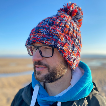 All of us at Waves and Wild Water LOVE this chunky knitted beanie hat in fab shades of red, orange, and blue - all the best colours of a beach campfire! The wild swimming community love it too because it's great for warming your head up after a dip!