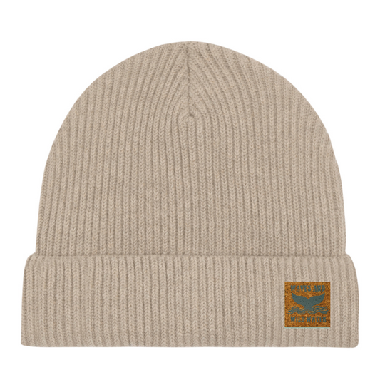 Sand Dune fisherman beanie hat with vegan cork 'leather' label. This bestselling hat from Waves and Wild Water is loved by wild swimmers, sea dippers, and the cold water community.