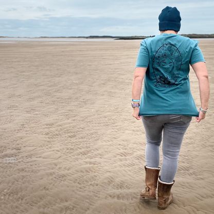 Wild swimmer and cold water enthusiast Claire, takes a break from sea dipping to walk the deserted Welsh beach. Her Stormy Sea fisherman beanie hat keeps her head cosy against the coastal wind.