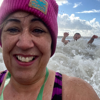 Braving the falling water temperatures as well as the waves, wild swimmers Claire and Glenn have fun in the sea in South Wales.