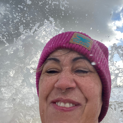 Wild swimmer Claire, lives up the her company name of Waves and Wild Water by being flattened by an unexpected wave. Not the most flattering picture, but she was having so much fun! And her bright pink Water Lily beanie hat ensures she will be seen beneath the waves!