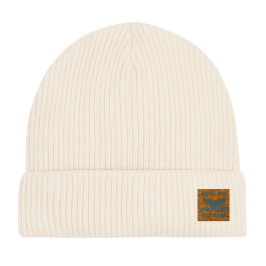 Winter Swim knitted fisherman beanie hat with vegan cork 'leather' label. This fabulous natural cream coloured hat from Waves and Wild Water, is constructed from GOTS organic cotton, and is loved by wild swimmers, sea dippers, and the cold water community.