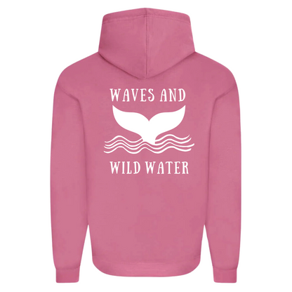The back of the Waves and Wild Water Sunset Blush hoodie showing the large whale tail logo coming out of the waves. The logo is hand printed in white vegan ink and contrasts perfectly with the blush pink of the hoodie, making this the go to choice for wild  simmers and sea dippers.