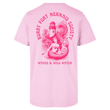 Pale pink cotton t-shirt featuring an illustrated mermaid with flowing hair in front of Burry Port lighthouse, with bold magenta water-based text.