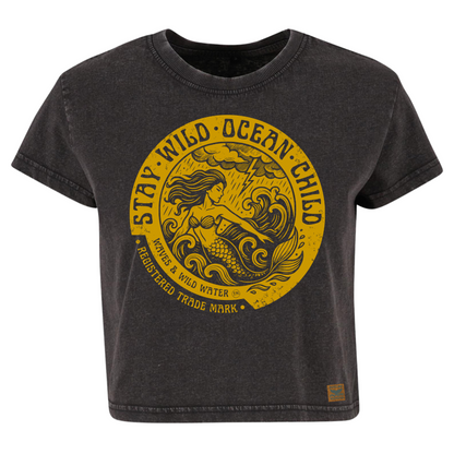 Vintage black cropped sustainable cotton t-shirt with metallic gold ink mermaid and stormy sea design framed by Stay Wild Ocean Child text.