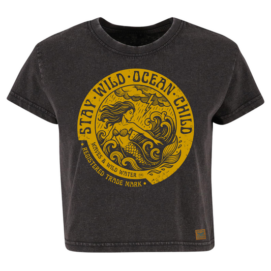 Vintage black cropped sustainable cotton t-shirt with metallic gold ink mermaid and stormy sea design framed by Stay Wild Ocean Child text.