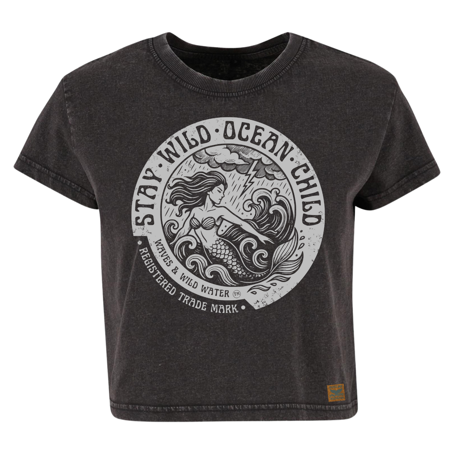 Vintage black cropped sustainable cotton t-shirt with metallic silver ink mermaid and stormy sea design framed by Stay Wild Ocean Child text. Exclusive to Waves & Wild Water.
