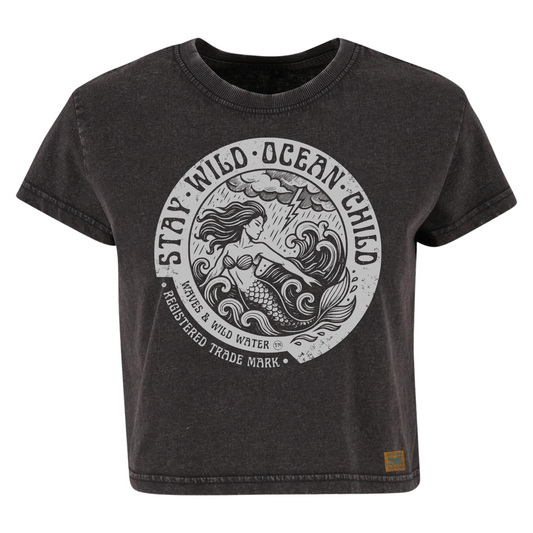 Vintage black cropped sustainable cotton t-shirt with metallic silver ink mermaid and stormy sea design framed by Stay Wild Ocean Child text. Exclusive to Waves & Wild Water.