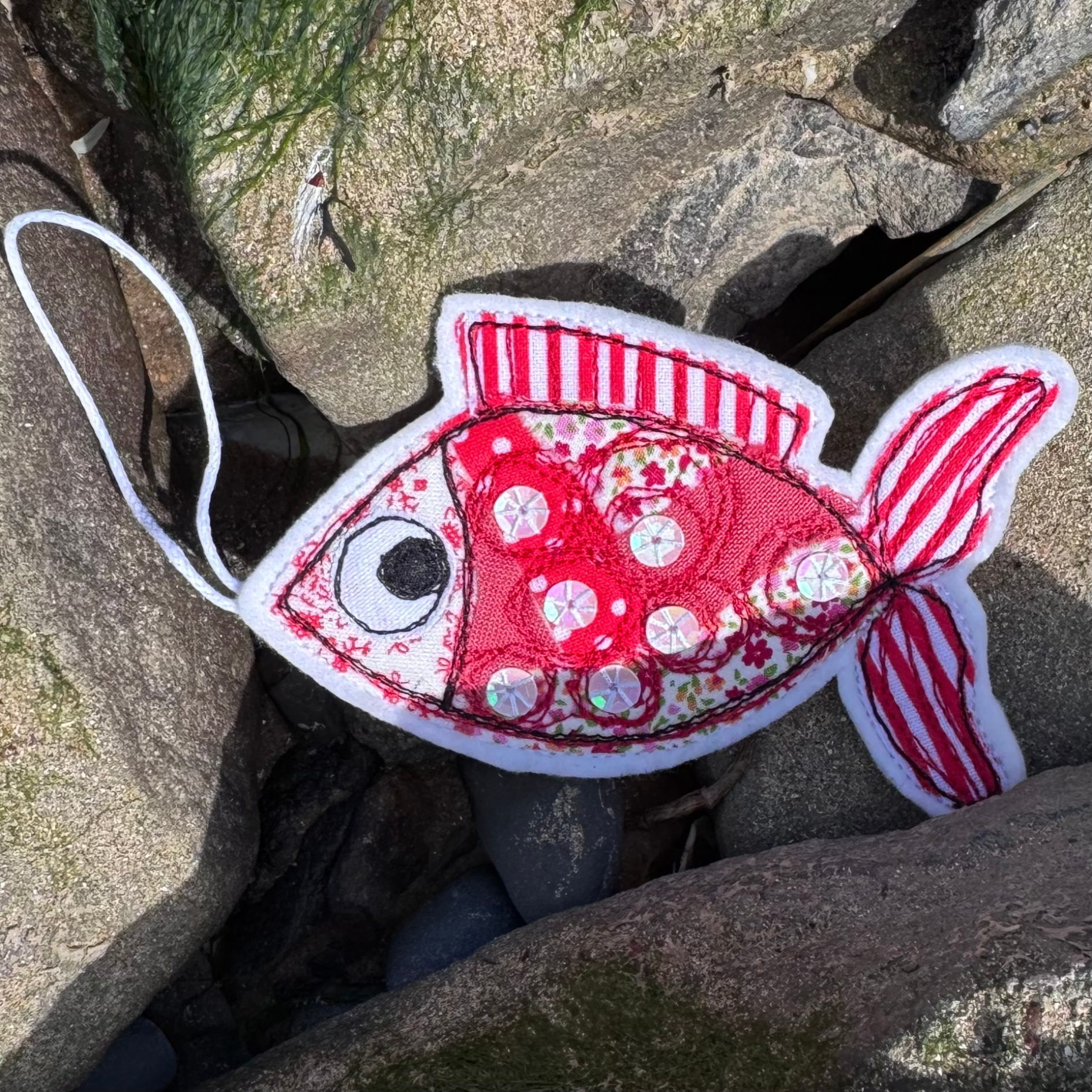 Handmade fabric fish decoration in red, a thoughtful coastal gift and keepsake for sea lovers and wild swimmers.