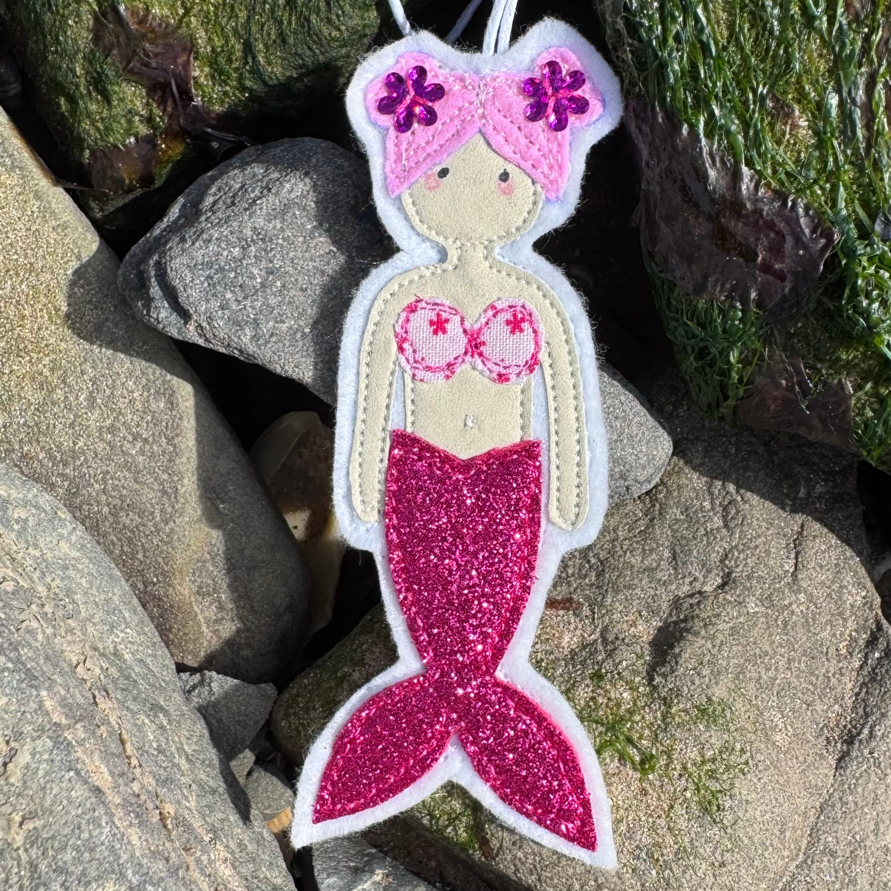 Handmade mermaid hanging decoration with pink glitter tail, a thoughtful coastal gift for sea lovers and wild swimmers.