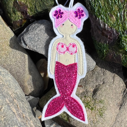 Handmade mermaid hanging decoration with pink glitter tail, a thoughtful coastal gift for sea lovers and wild swimmers.