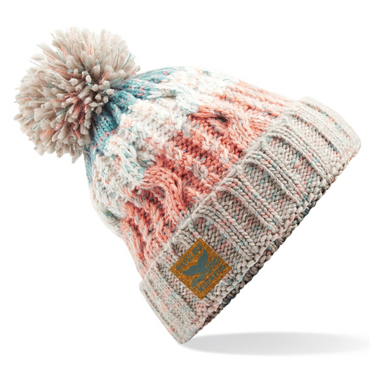 A cream and peach coloured knitted beanie hat with pom pom.
