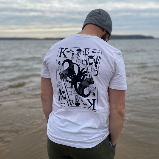 A man's back with a t-shirt showing a printed t-shirt with a merman king and an octopus.